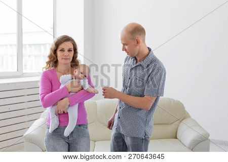 Family, Childhood And Parenthood Concept - Father, Mother Holding Cute Baby Indoors