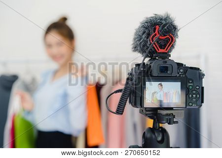 Asian Fashion Female Blogger Online Influencer Holding Shopping Bags And Lots Of Clothes On Clothes 