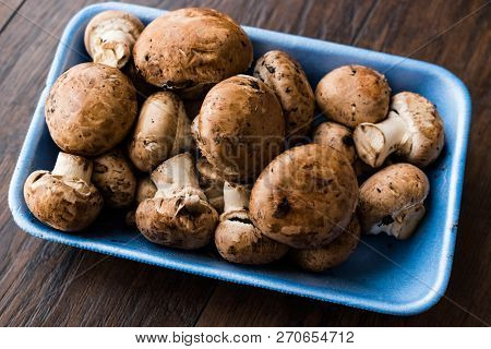 Portobello Raw Cremini Mushrooms In Plastic Container Package Or Box.