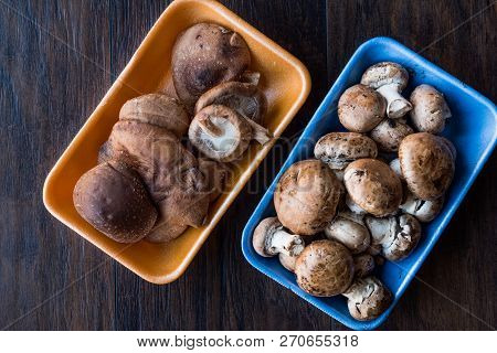Shiitake And Cremini Mushrooms In Plastic Container Package Or Box.