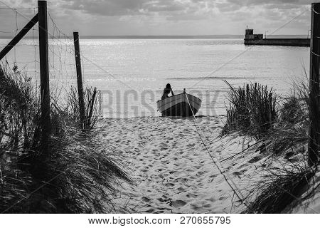 Silhouette Of A Young And Nice Girl On The Boat At The Seaboard