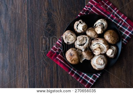 Portobello Raw Cremini Mushrooms In Black Plate.