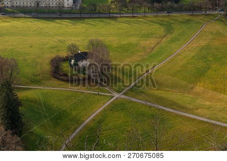 Park With Crossroads And Green Grass Behind The Castle