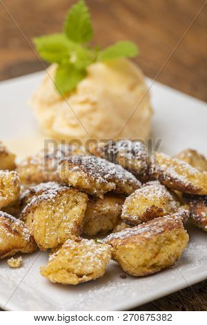 Austrian Kaiserschmarrn On Dark Wood With Ice