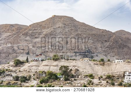 Close-up Of The Mount Of Temptation From Jericho City Plagued By Constructions And Millenary Excavat