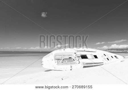 Ship Or Luxury White Boat Lay On Sand Beach, Skyline Background. After Storm Always Return Sun. Yach