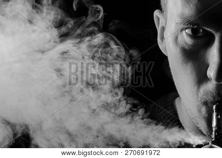 Portrait Of A Half Part Of Guy With A Shadow On A Serious Face  With A Colored Backlight Of Monochro