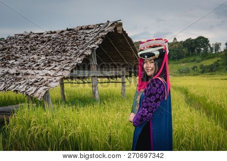Portrait Of Lisu Girl In Traditional Dress In The Rice Fields.