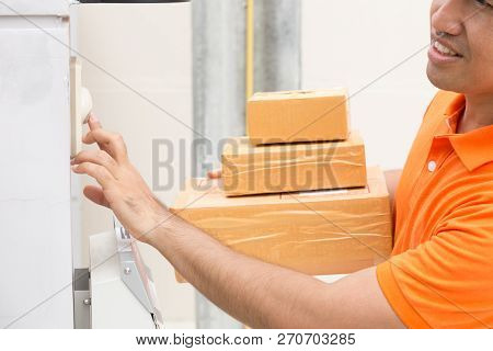 Delivery Man Ring A Bell To Call Customers For Receive A Parcel At Front Home