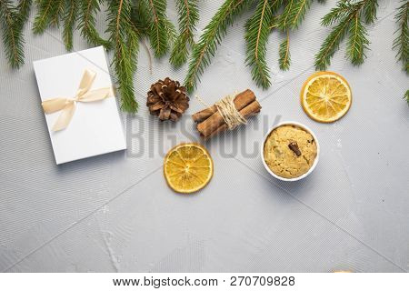 Christmas Tree Pine Brancheswith Present, Orange, Cake, Cinnamon On Grey Background. Toned