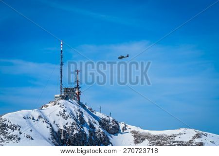 Helicopter Flying Above Telecommunication Station On The Stirovnik Peak, The Highest Summit Of The L