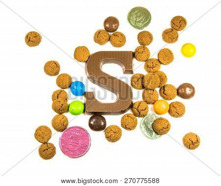 Bunch Of Pepernoten Strooigoed With Chocolate Letter S, Top View On White Background For Annual Sint