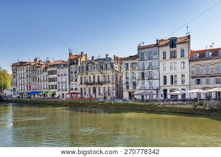 Nive River Embankment With Historical Houses In Bayonne, France