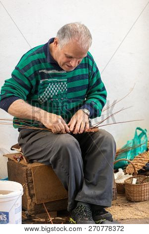 Camacha, Madeira, Portugal - April 19, 2018: A Basket Weaver At Work In The Factory Shop In Camacha 