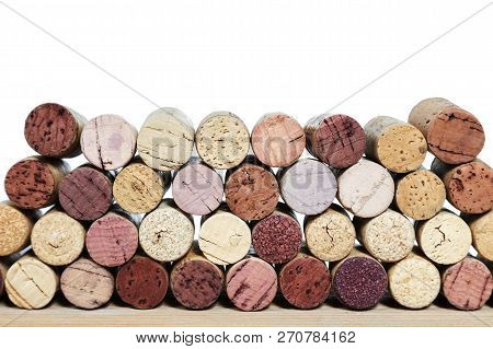 Multicolored Bright Corks From Wine Bottles On A Wooden Table Isolated On A White Background. Rows O