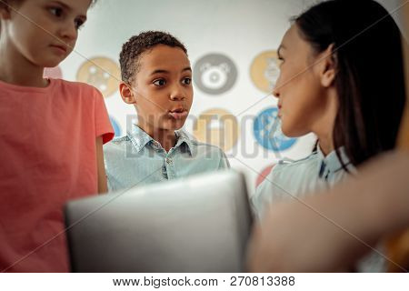 Handsome Dark-skinned Boy Looking At His Teacher