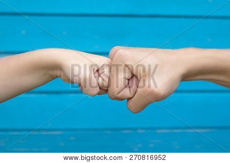 Power Five, Fist Bump Or Brofist. Close-up Of Child And Father Fists Touching Each Other