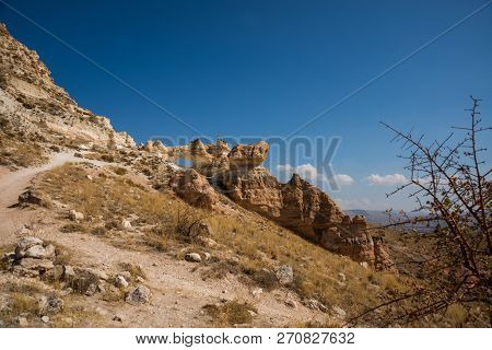 Unusual Rock On A Hill With A Hole. Beautiful Landscape In Sunny Autumn Weather. Cappadocia, Turkey