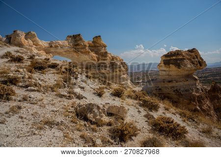 Unusual Rock On A Hill With A Hole. Beautiful Landscape In Sunny Autumn Weather. Cappadocia, Turkey