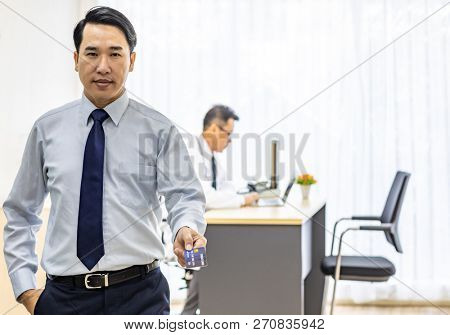 Portrait of Young adult Patient with credit card with examination room medical office background for insurance concept