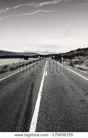 Stright Asphalt Road Of Europe Peaks In Spain Early Morning. Spanish Landscape At Sunrise, Hills, Pa