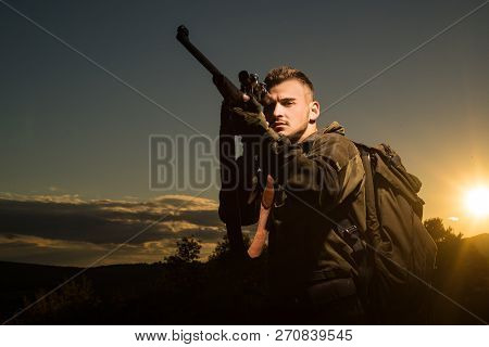 Track Down. Rifle Hunter Silhouetted In Beautiful Sunset. Most Realistic Hunting Game Ever Created. 