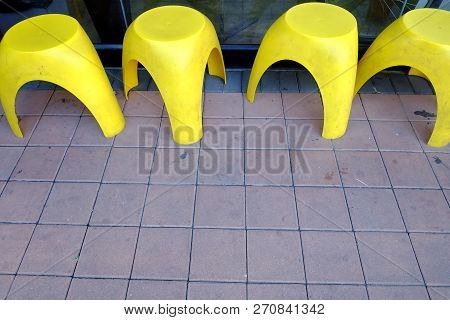 Yellow Low Seats On The Street Footbath And For A Customer Sitting And Waiting Outside The Building