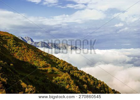 Landscape - View From The Mountain Top On A Sunny Day To The Valley Hidden By Low Clouds