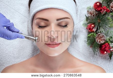 The Cosmetologist Makes The Procedure Microdermabrasion Of The Facial Skin Of A Beautiful, Young Wom