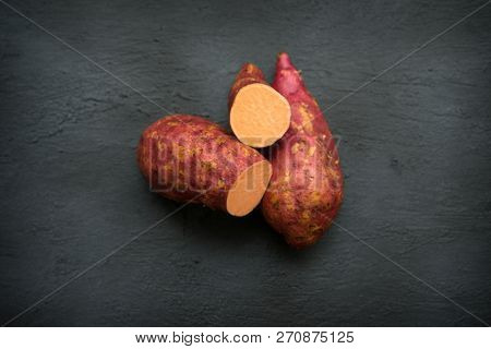 Sweet potato on the wooden table. Top view.
