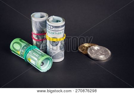 Bitcoins Lie On A Dark Background With Dollars And Euro Tubule, Close-up
