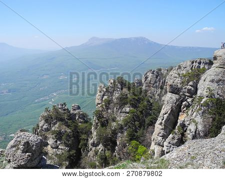 Beautiful Mountain Landscape With Sheer Cliffs. Distant Mountain Plateaus In A Blue Haze. Crimean Mo