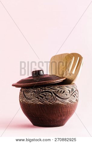 Pots And Plates Of Clay On A White Table And A Pink  Background. Clay Pottery Kitchen Utensils Made