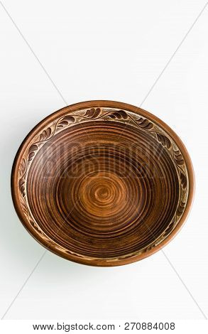 Pots And Plates Of Clay On A White Table And A Blue Background. Clay Pottery Kitchen Utensils Made B