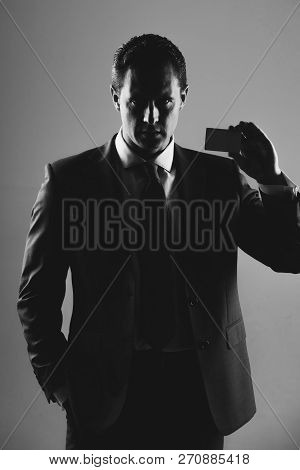 Man, Businessman Or Manager Holding Bank Or Business Card In Stylish Blue Formal Suit And Tie On Gre