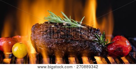 Fresh Fillet Steak On Grill With Flammes.