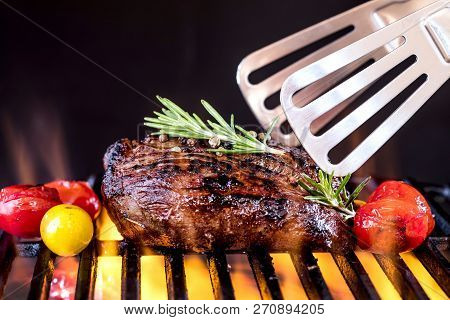 Fresh Fillet Steak On Grill With Flammes.