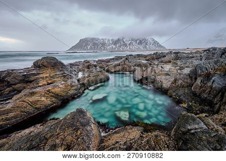 Rocky coast of fjord of Norwegian sea in winter. Lofoten islands, Norway