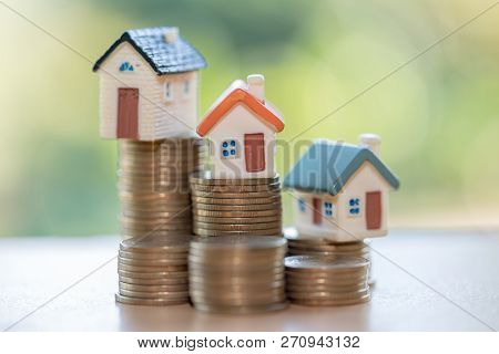Mini House On Stack Of Coins,money And House,  Mortgage, Savings Money For Buy House And Loan To Bus