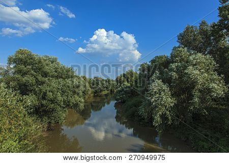 Beautiful Landscape With Blue Sky And White Clouds Reflected In The River Water