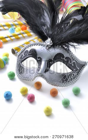Carnival Mask Among Colorful Cotillon On White Background
