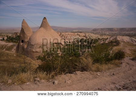 Uchisar, Cappadocia, Turkey: The Road Leads To The City And Uchisar Castle. Rock Houses And Churches