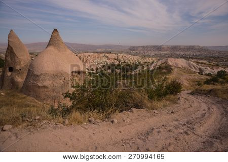 Uchisar, Cappadocia, Turkey: The Road Leads To The City And Uchisar Castle. Rock Houses And Churches