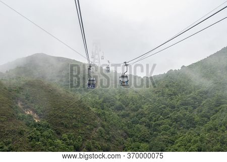 Ngong Ping, Hong Kong, May 2018 - View Of The Ngong Ping 360 Cable Cars Going Into The Cloud, Lantau