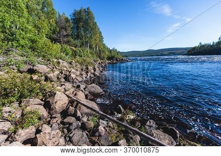 View Of Kalix River, Kalixalven, Overkalix Locality And The Seat In Norrbotten County, Sweden, With