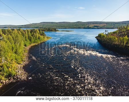 View Of Kalix River, Kalixalven, Overkalix Locality And The Seat In Norrbotten County, Sweden, With