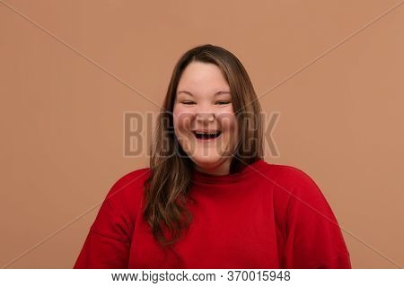 A Squishy Smile Of A Girl With Narrow Gals. A Bright Blouse.