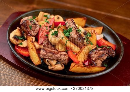Hot Frying Pan With Potatoes, Meat, Peppers On Stand