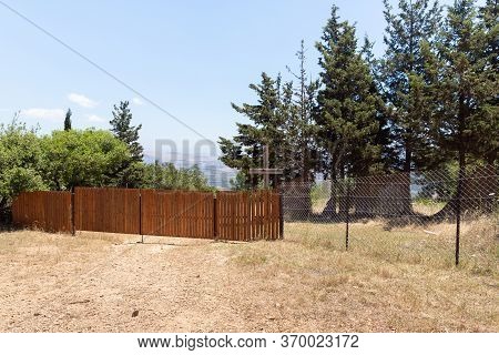 Outdoor Fence With A Large Wooden Cross Enclosing The Monastery Of Lavra Netofa Near The Village Of 