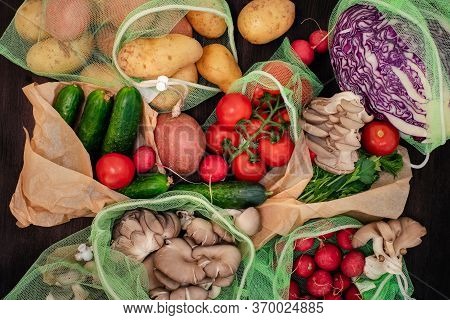 Vegetables In Reusable Net Bags On Grey Wooden Background, Top View. Zero Waste And Eco Friendly Con
